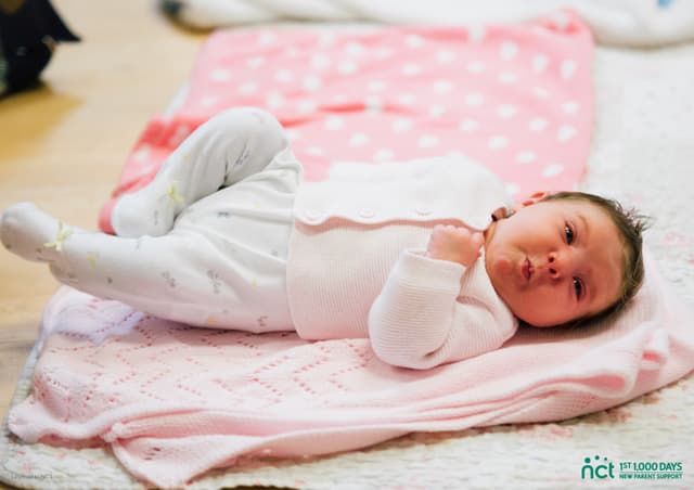 Baby lying on play mat